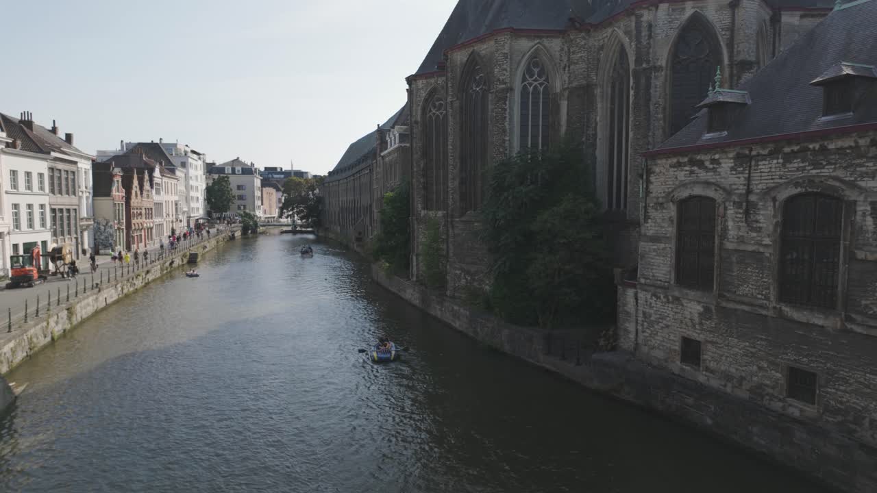 A serene canal view in Ghent with Saint Michael's Church, showcasing calm outdoor charm