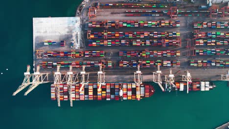 aerial top down view of port with stacked of colorful containers and cranes in koper, capo d'istria, slovenia