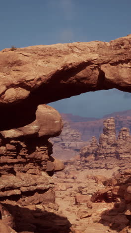 red rock archway in a desert landscape