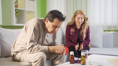 Worried-Woman-is-sad-and-hopeful-looking-at-her-sick-husband.