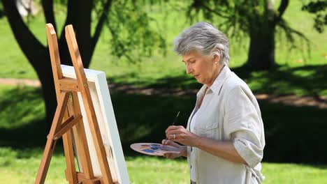 old female painting a canvas