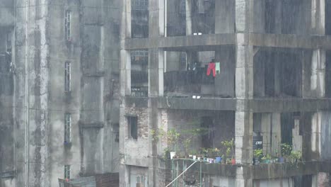 rain-soaked concrete building with laundry drying