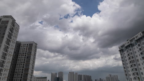 urban time lapse featuring dramatic tropical storm and rain clouds, high rise apartment buildings, and interesting moving highlights and shadows