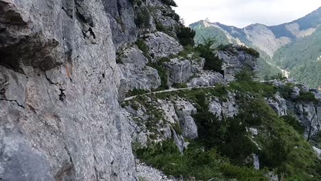 a dangerous path in the mountains with beautiful nature in the background