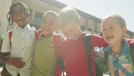 video of happy diverse boys walking and laughing in front of school