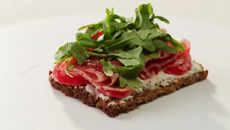 delicious whole grain sandwich with tomatoes and arugula
