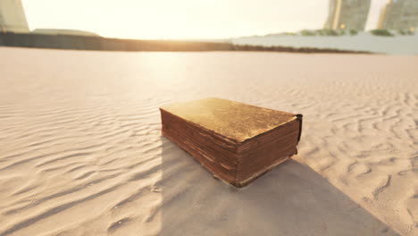 old book on the beach at sunset