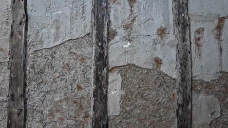 Ancient-mortar-wall-with-wooden-frame---isolated-detail-close-up