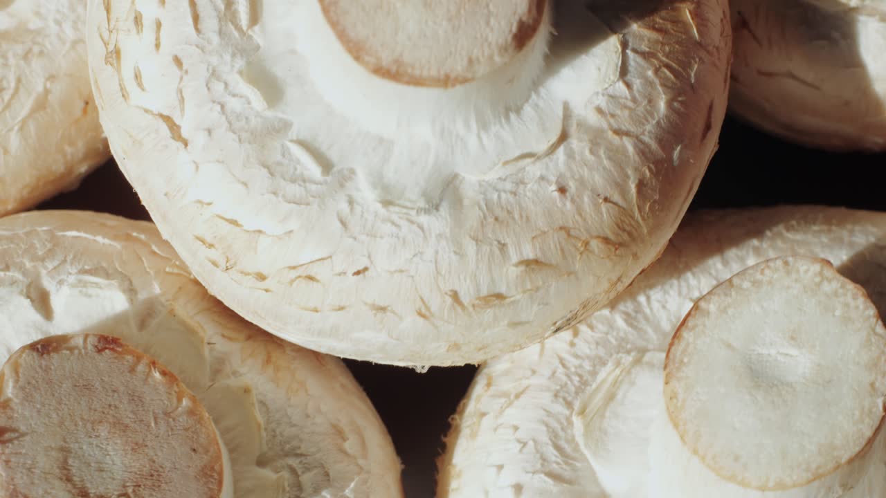 Freshly picked mushrooms on home kitchen, close up texture of brown Champignon, woman cooking tasty vegan dinner.