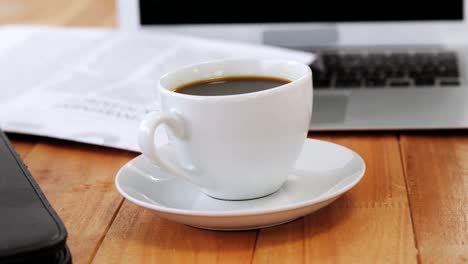 coffee cup with file folder and laptop