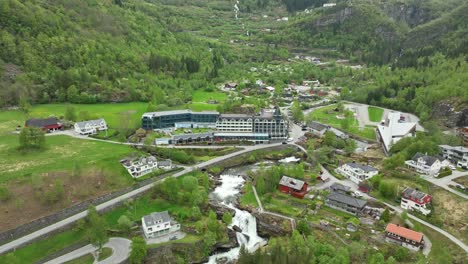 Approaching-Hotel-Union-and-Fjord-Centre-in-beautiful-town-of-Geiranger-Norway---Aerial-from-may-month-during-spring