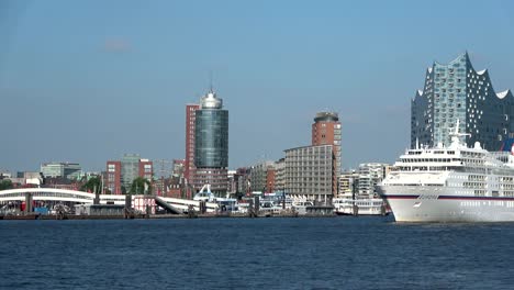 cruise liner in hamburg on departure, elbe and cityscape,