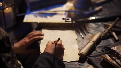 man writing with a feather pen.