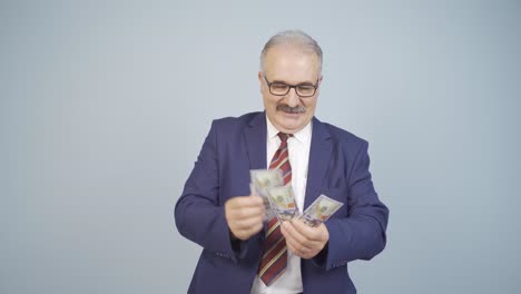 hombre de negocios contando dinero mirando a la cámara.