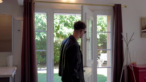 two young men opening front door and walking inside the house.
