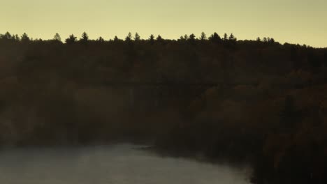 low-angle aerial of onawa trestle bridge view through morning fog
