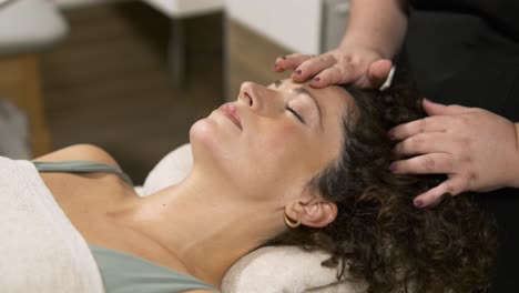 skilled beautician providing a relaxing facial massage to a woman