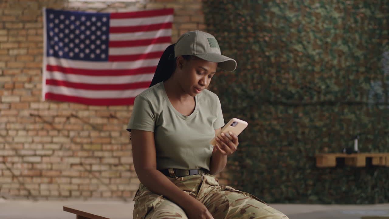 Military personnel using a smartphone in a military base
