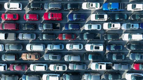 top down aerial of cars parked in tight spaces