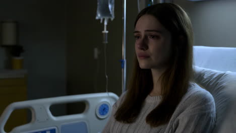 sad girl in hospital bed