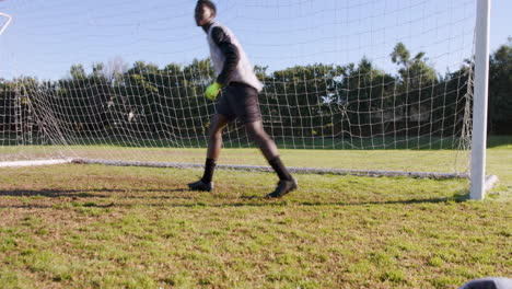 goalkeeper in soccer uniform standing in goal, ready to defend shot