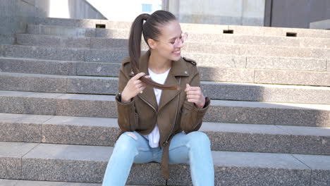 stylish woman sitting on stairs