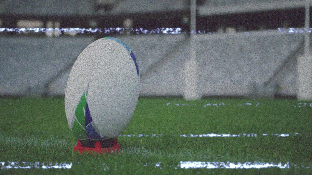 Rugby ball on tee with animation of static interference in stadium background