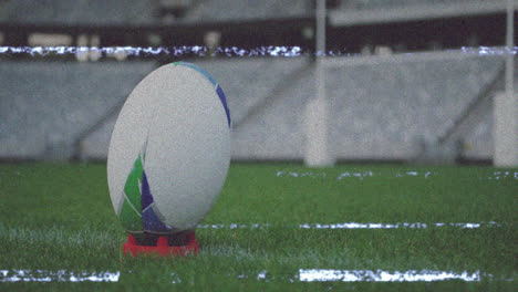 rugby ball on tee with animation of static interference in stadium background