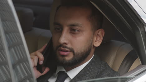 having business call behind car door