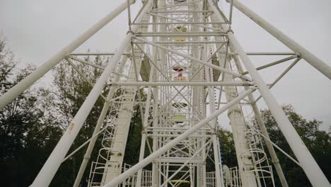 panorama of a rotating ferris wheel in the mountains among nature. shooting with a wide-angle lens