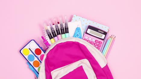 pink backpack with school tools move left right on pink theme. stop motion