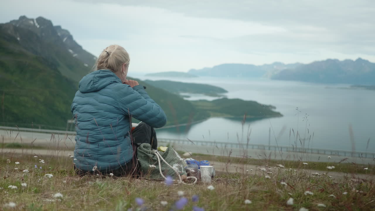 Nordic Blonde Girls Sitting in the Grass and Having Picnic in a Beautiful Norwegian Fjord, Hiker Girl Eating Lunch, Kv&aelig;nangsfjell Gildetun, S&oslash;rstraumen