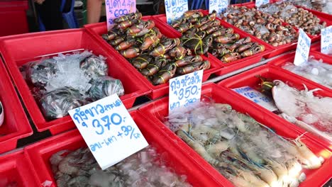 various seafood items for sale at a market stall