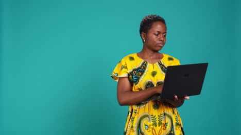 young woman freelancer navigating on online webpages in studio