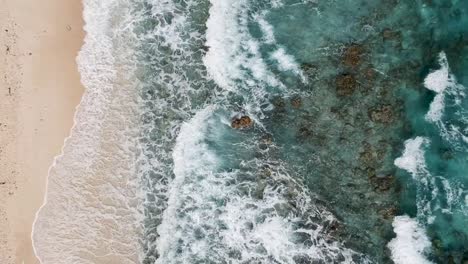 drone footage of crystal clear blue water and waves on the shore of beach in cebu philippines-12