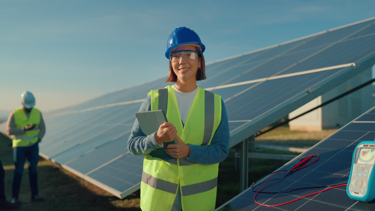 Engineer inspecting solar panels at a solar farm