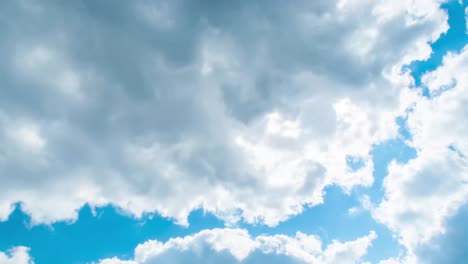 time lapse clip of white fluffy clouds over blue sky