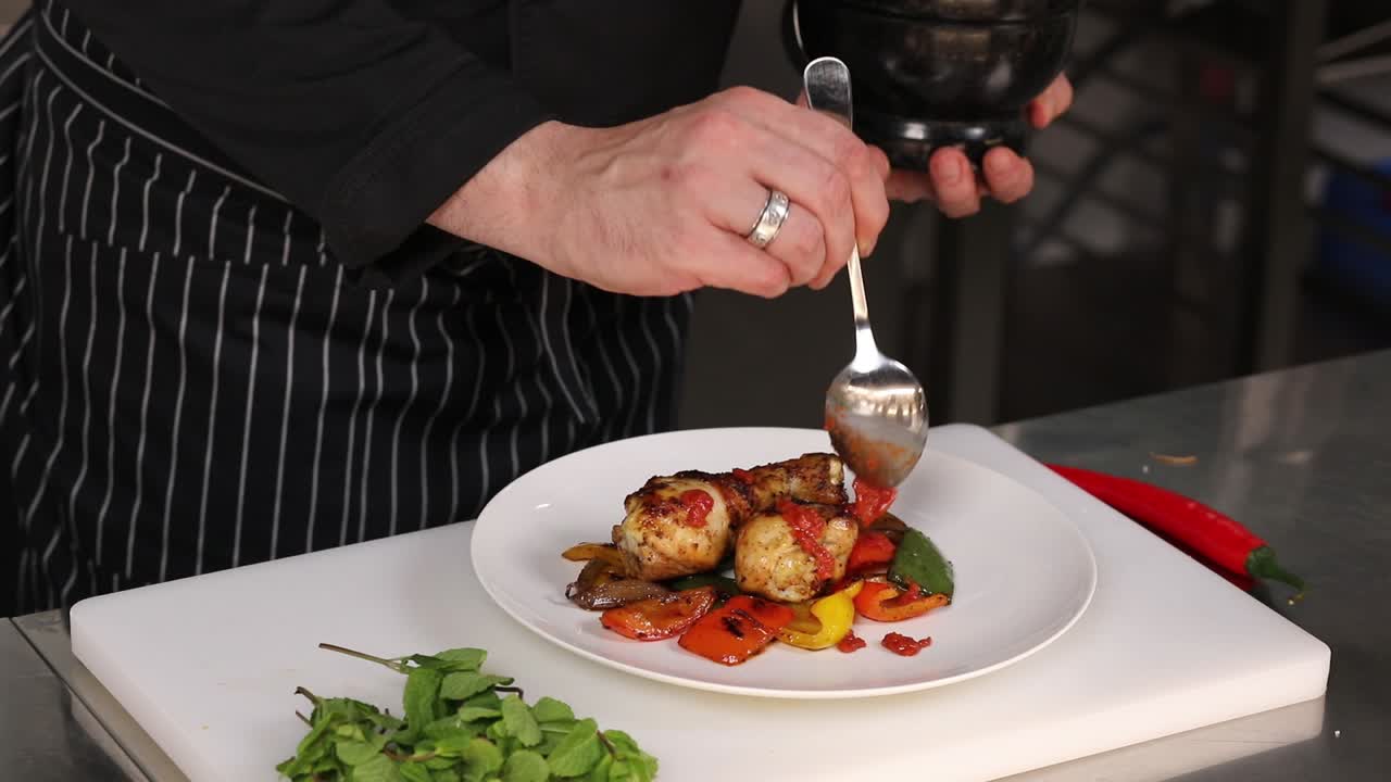 Chef preparing roasted chicken with vegetables
