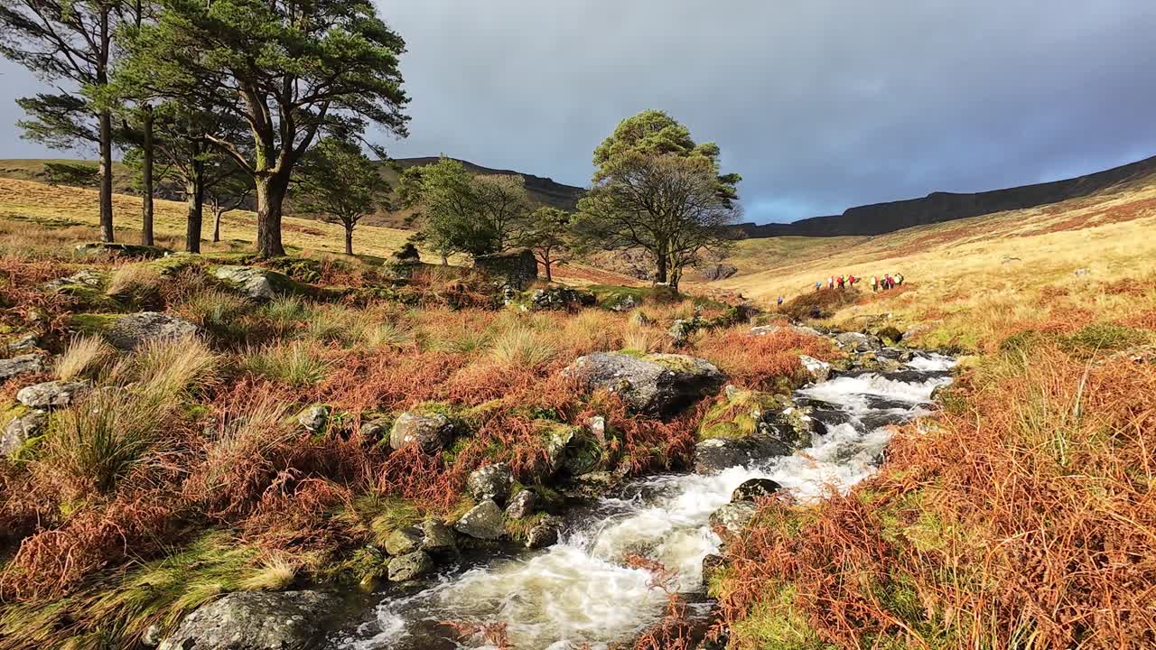 Irish mountain scenery hillwalkers in The Comeragh Mountains on a bright winter day Epic Locations and landscapes Irish countryside and mountain stream
