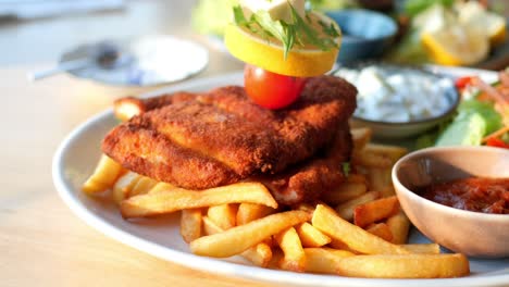 delicious fried chicken with fries and salad