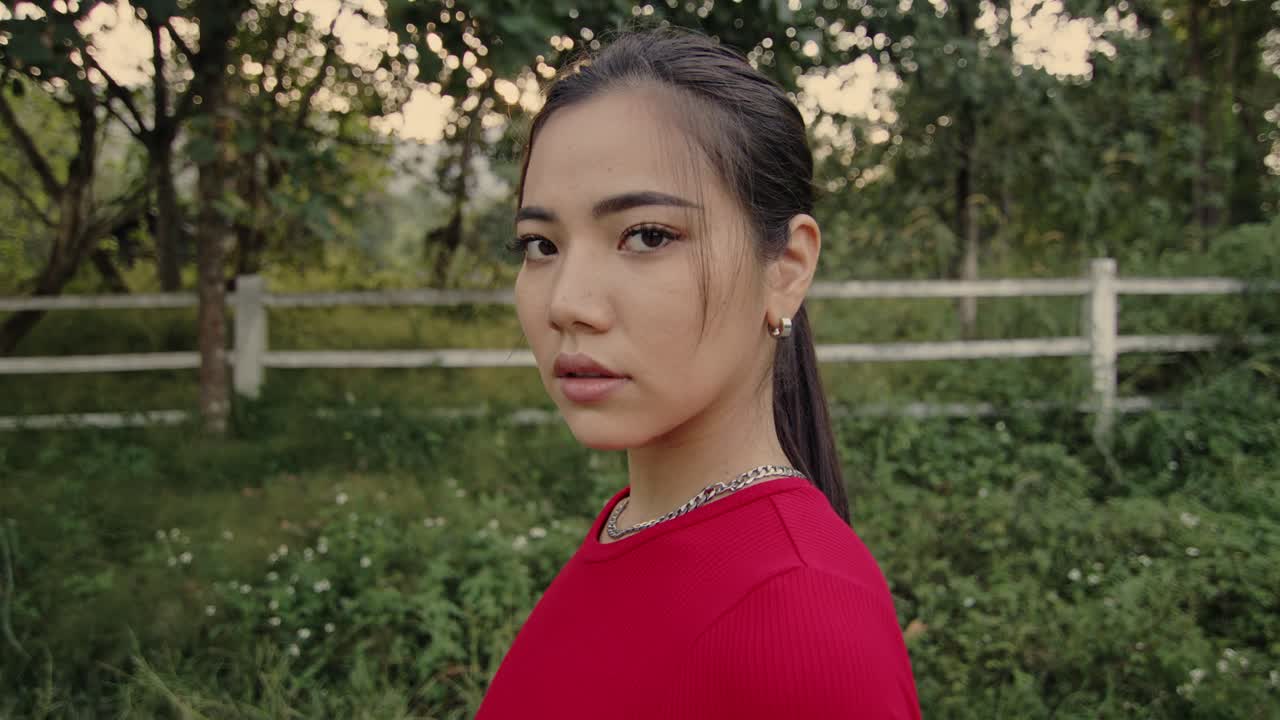 Young Woman in Red Shirt Outdoors