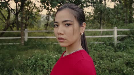 young woman in red shirt outdoors