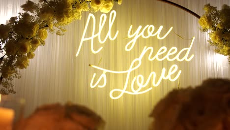 "all you need is love" - neon sign hanging on a decorative wall