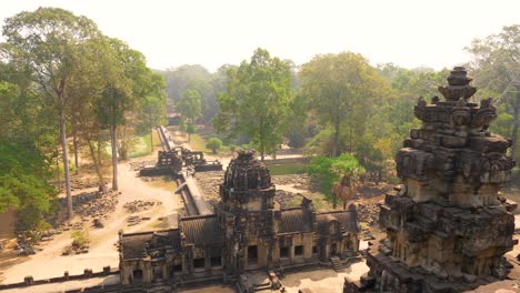 a couple sits on the edge of a stunning temple complex, bathed in morning sunlight. the camera gracefully moves through grand pillars, showcasing the beauty of the surroundings.