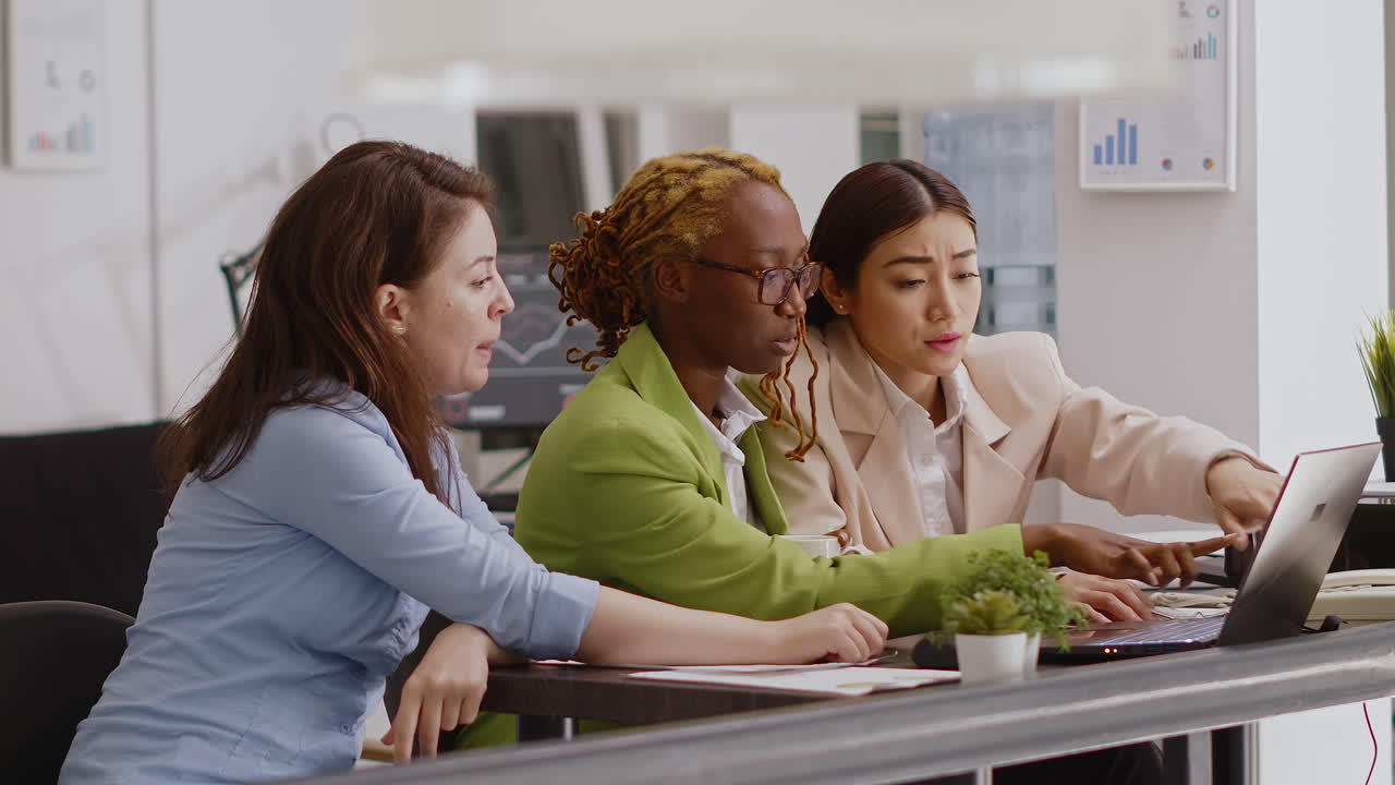 Three Business Women Collaborating in Office Meeting