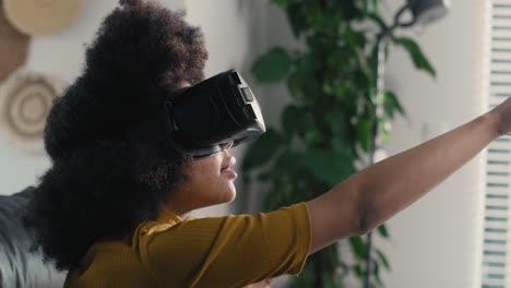 teenage girl wearing virtual reality simulator to play video game in the living room