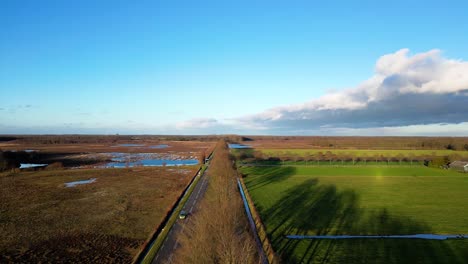 aerial view of dutch countryside landscape with road and marsh