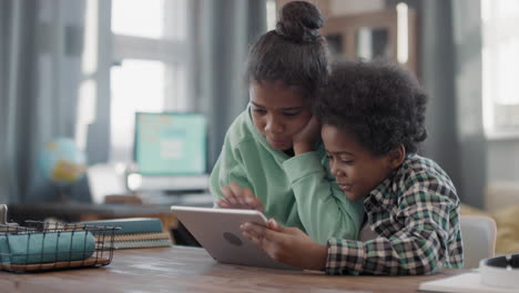 afro kids playing digital tablet together
