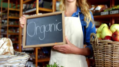 female staff holding organic sign board