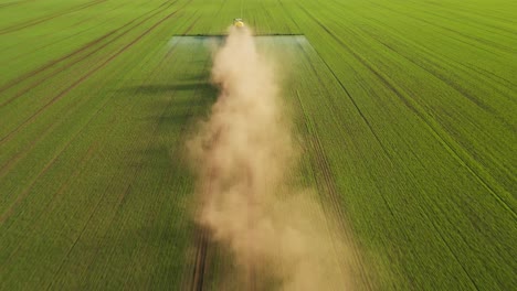 aerial view of a tractor spraying a field